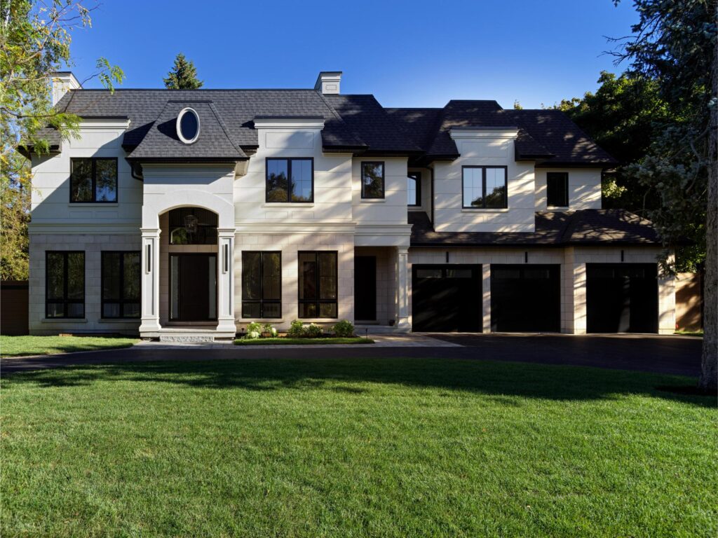 Traditional custom home on Portway Avenue with natural stone detailing and balanced proportions